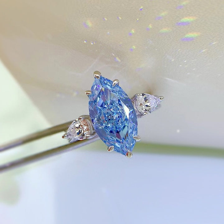 Ice Blue Promise · Marquise Solitaire & Pear Three-Stone Ring